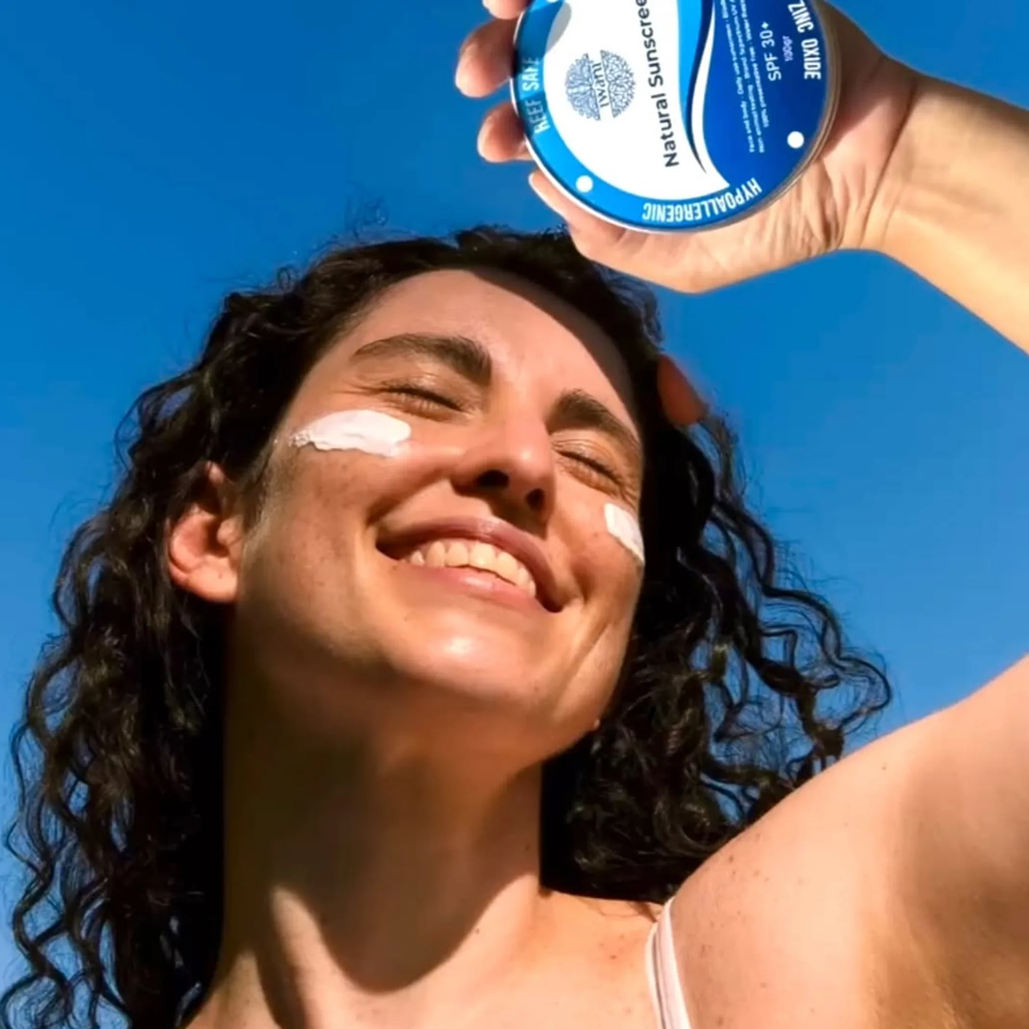 bottle of hypoallergenic sunscreen on table